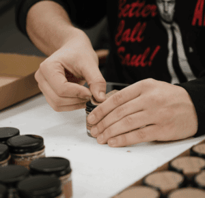 This image shows one of our employees hand labeling a salt jar. 